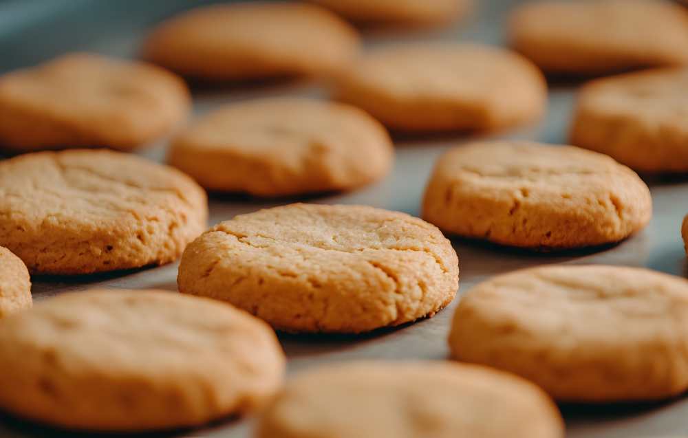 A stack of thin, rectangular wafer cookies in assorted flavors arranged beautifully on a plate