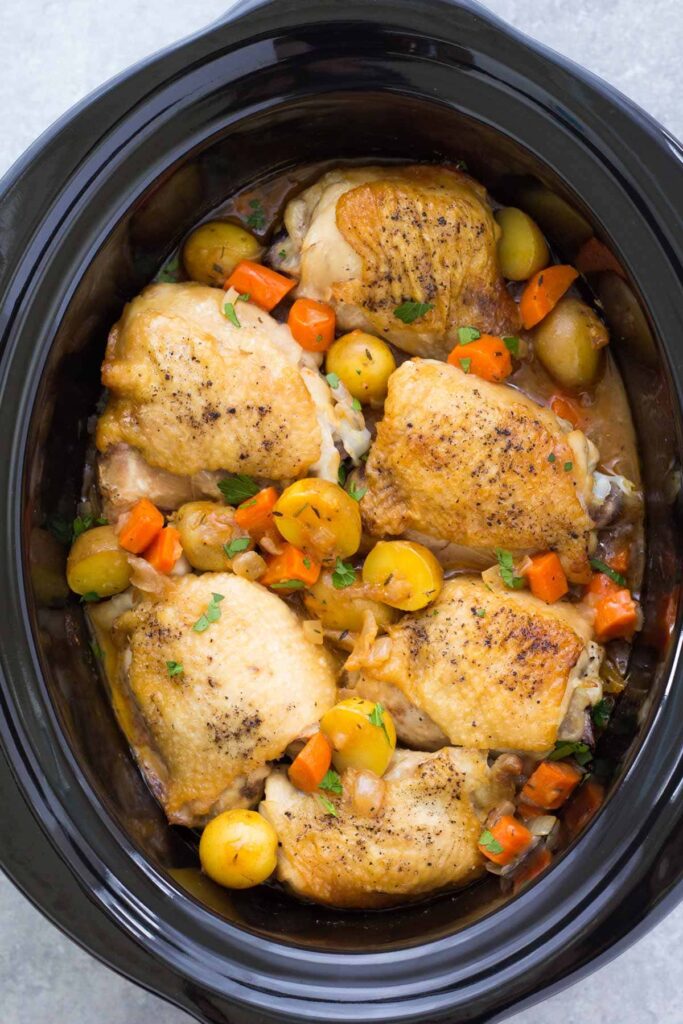 Frozen chicken breasts placed in a crock pot, ready to be slow-cooked to perfection.