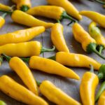 A bunch of ripe banana pepper with their signature curved shape and mild flavor, ideal for salads, sandwiches, and more.