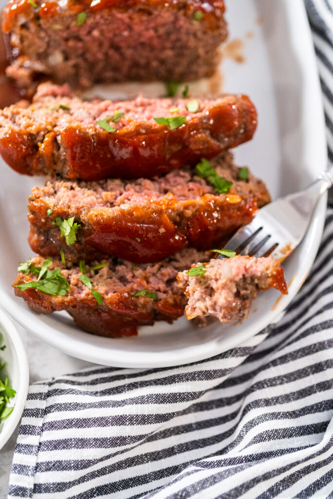 A juicy and perfectly glazed meatloaf sliced to reveal its tender, moist interior